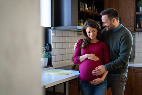 Man in love hugs his pregnant wife, they are waiting together for the baby's arrival. Love, family