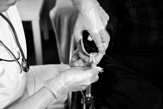 Doctor performing blood sugar test and injecting insulin for diabetes patient