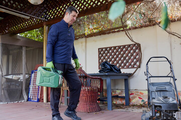 A middle-aged man takes care of the garden of his house, doing various maintenance tasks with the help of his wife.