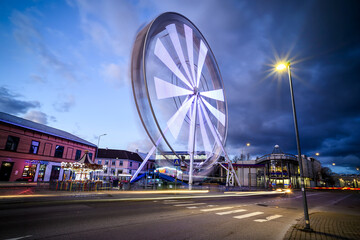 A Ferris wheel against a nighttime blue sky.