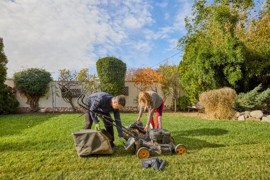 A middle-aged man and his wife work in the garden and do various maintenance activities. - Powered by Adobe