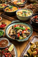 many different thai food dishes on table in modern restaurant in bangkok thailand