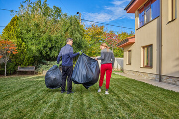 A middle-aged man and his wife work in the garden and do various maintenance activities.