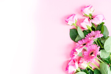 wedding or mothers day background, bouquet of roses and herberas over plain pink background