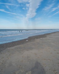 Fototapeta premium lonely beach with waves and sky in zeeland, the netherlands