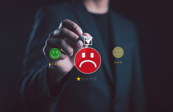 business professional selecting a negative satisfaction rating on a digital interface, featuring a red unhappy face, one-star review, and feedback options representing poor customer experience.