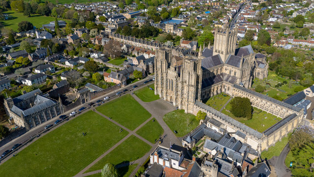 Aerial view of the majestic Wells Cathedral, its stones in sharp relief against the surrounding green, a testament to time and faith, Wells, England, United Kingdom.