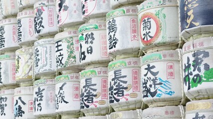 Traditional sake barrels stacked in a Japanese shrine.