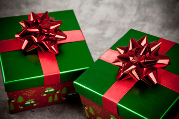 Christmas shiny gift box with a bow on a rustic background