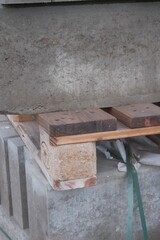 Stacked concrete blocks on wooden pallets at construction site