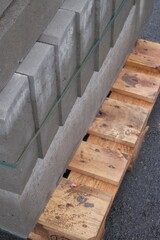 Stacked concrete blocks on wooden pallets at construction site
