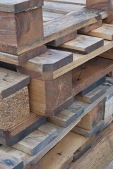 Stack of wooden beams and planks at construction site