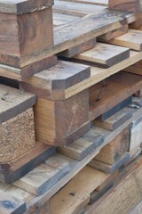 Stack of wooden beams and planks at construction site