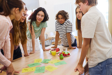 Group of students discussing healthy food options in a school setting