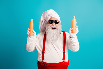 Funny santa lookalike with towel hat red suspenders and orange bottles creates festive holiday vibe for christmas themed stock image