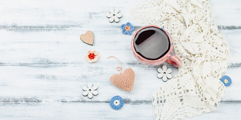 A cup of fragrant hibiscus tea and cute handmade decor. Good mood concept, cozy home comfort