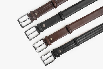 Leather Belts in Row on White Background