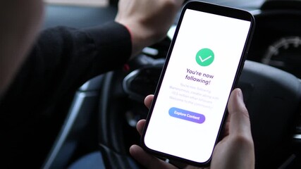 A user expands his digital network by subscribing to a popular blog account through a simple tap interaction. This footage effectively illustrates modern audience building and content consumption