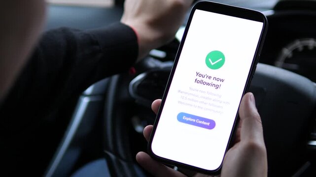 A user expands his digital network by subscribing to a popular blog account through a simple tap interaction. This footage effectively illustrates modern audience building and content consumption - Powered by Adobe
