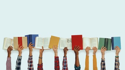 Row of diverse hands holding open hardcover books against a light background. Education and literacy concept with copy space for text