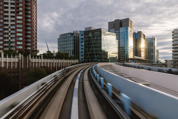 Monorail track curving through modern city buildings