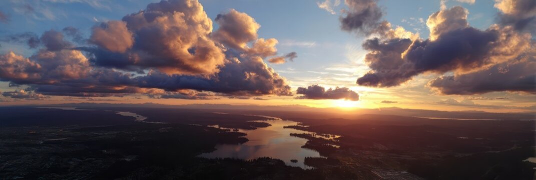 Aerial View of Lake Stevens at Sunset: Vibrant Sky with Orange Hues and Soft Clouds in a Serene Natural Landscape