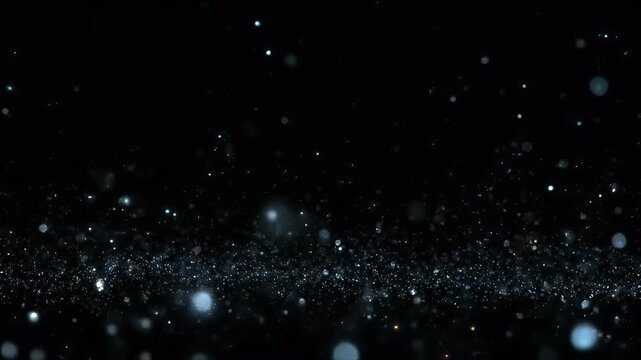 A dynamic field of glowing blue and white particles against a black background suggesting stardust or bokeh effects.