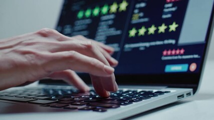 User types on laptop keyboard while engaging with an online platform for work or study in a modern indoor environment