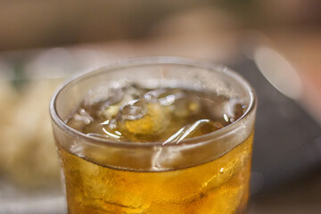 iced tea served in a glass with visible ice cubes