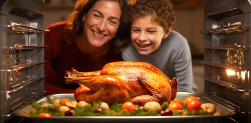 Excited Mother and Son Watching Turkey in Oven