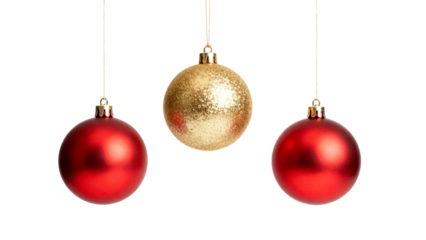 Red and gold ornaments hanging against a white background during the holiday season