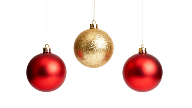 Red and gold ornaments hanging against a white background during the holiday season