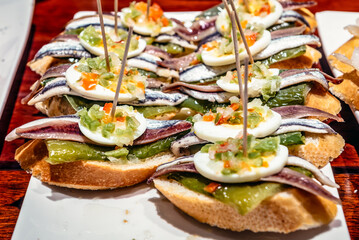 Obraz premium Plate with traditional Spanish snacks called pinchos in San Sebastian city also called Donostia in Gipuzkoa region of Spain