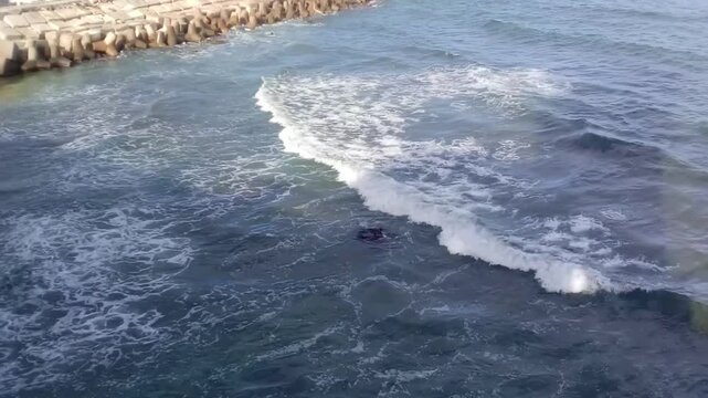 A great view of some rocks and the Mediterranean Sea is next to Stanley Bridge on the Corniche Road in Alexandria, Egypt. The bridge is 400 meters long. It has a pedestrian walkway.