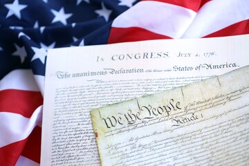 Constitution of the USA with US flag. Aged historical documents Washington DC on American Declaration of independence