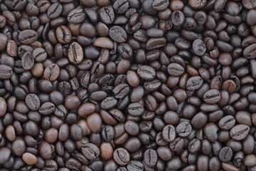 Pile of fresh roasted brown coffee beans close up. Food photo for backdrops
