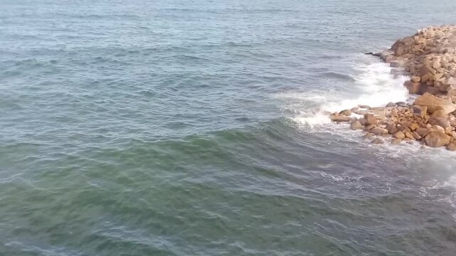 A great view of some rocks and the Mediterranean Sea is next to Stanley Bridge on the Corniche Road in Alexandria, Egypt. The bridge is 400 meters long. It has a pedestrian walkway.