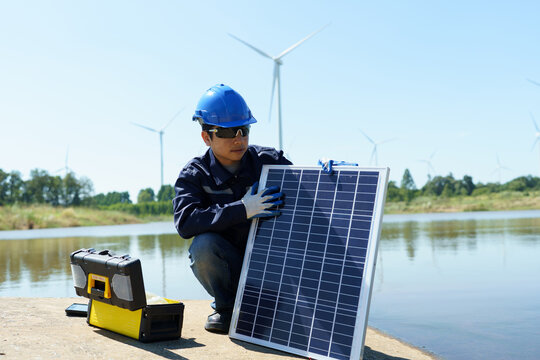 Engineering technicians are working to check the operation of solar panels in wind farms and inspect the electricity. - Powered by Adobe