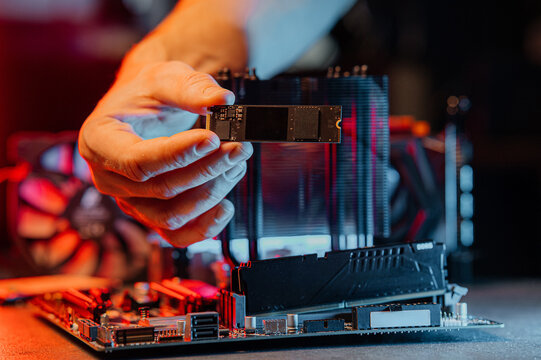 SSD M2 disk close up with selective focus on the interface. On dark background with reflection