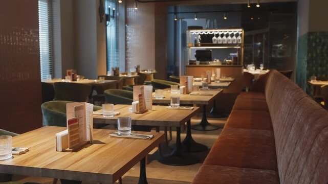 unoccupied city cafe, unfilled metropolitan restaurant space with seating and lighting fixtures present