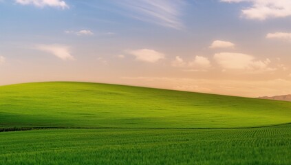Fototapeta premium Lush Green Hills Under a Beautiful Sky at Golden Hour Sunset