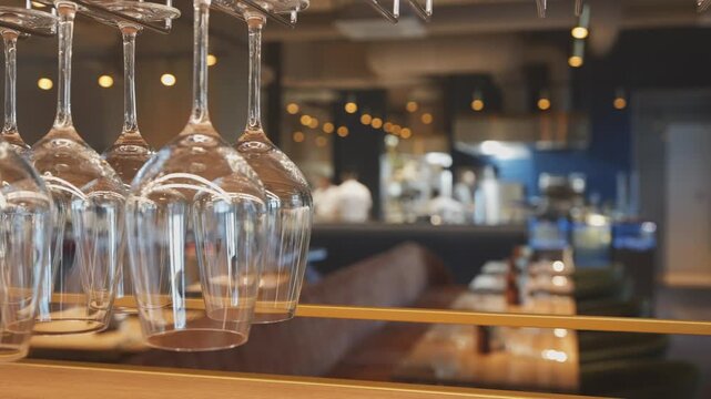 upscale lounge with wine display, chic bar environment featuring illuminated glasses and lively staff