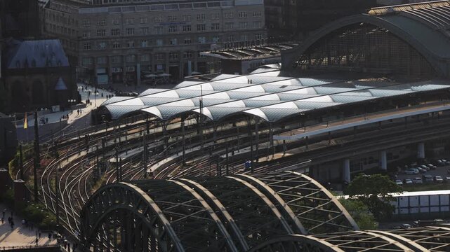 Establishing aerial shot of Hauptbahnhof Hbf train station in Cologne, Germany at sunset