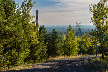 Steel  shaft tower and  of and  chimney of the disused Boże Dary mine  view from the Kostuchna slag heap.  Katowice, Silesia, Poland