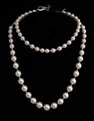 Two-strand pearl necklace on black backdrop