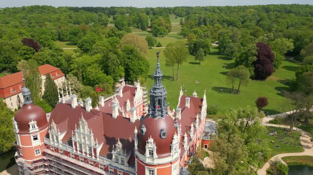 Aerial view of Muskau Castle in F&uuml;rst P&uuml;ckler Park, Bad Muskau, surrounded by wide green areas, trees, and a picturesque landscape park.