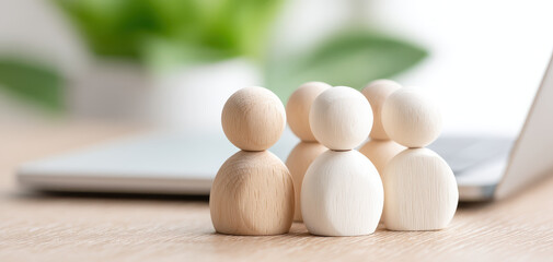 Wooden figures symbolize teamwork and leadership in corporate setting, showcasing collaboration and unity in professional environment