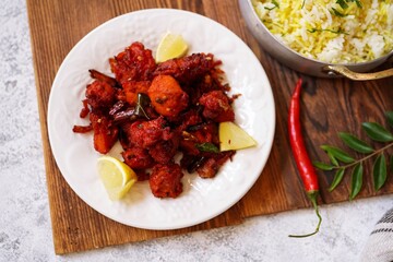Homemade Chicken 65 - Popular Indian bar ppetizer  served with saffron rice