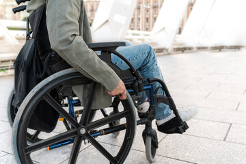 Obraz premium Close up of unrecognizable man sitting in a wheelchair on an urban bridge