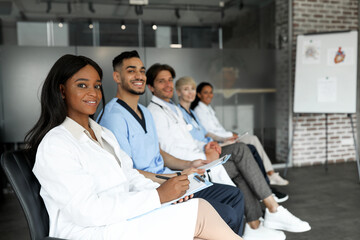 Professional international group of male and female healthcare employees having medical conference...